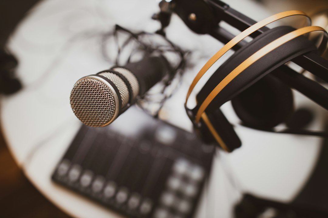 Professional microphone and headphones in an audio broadcast studio