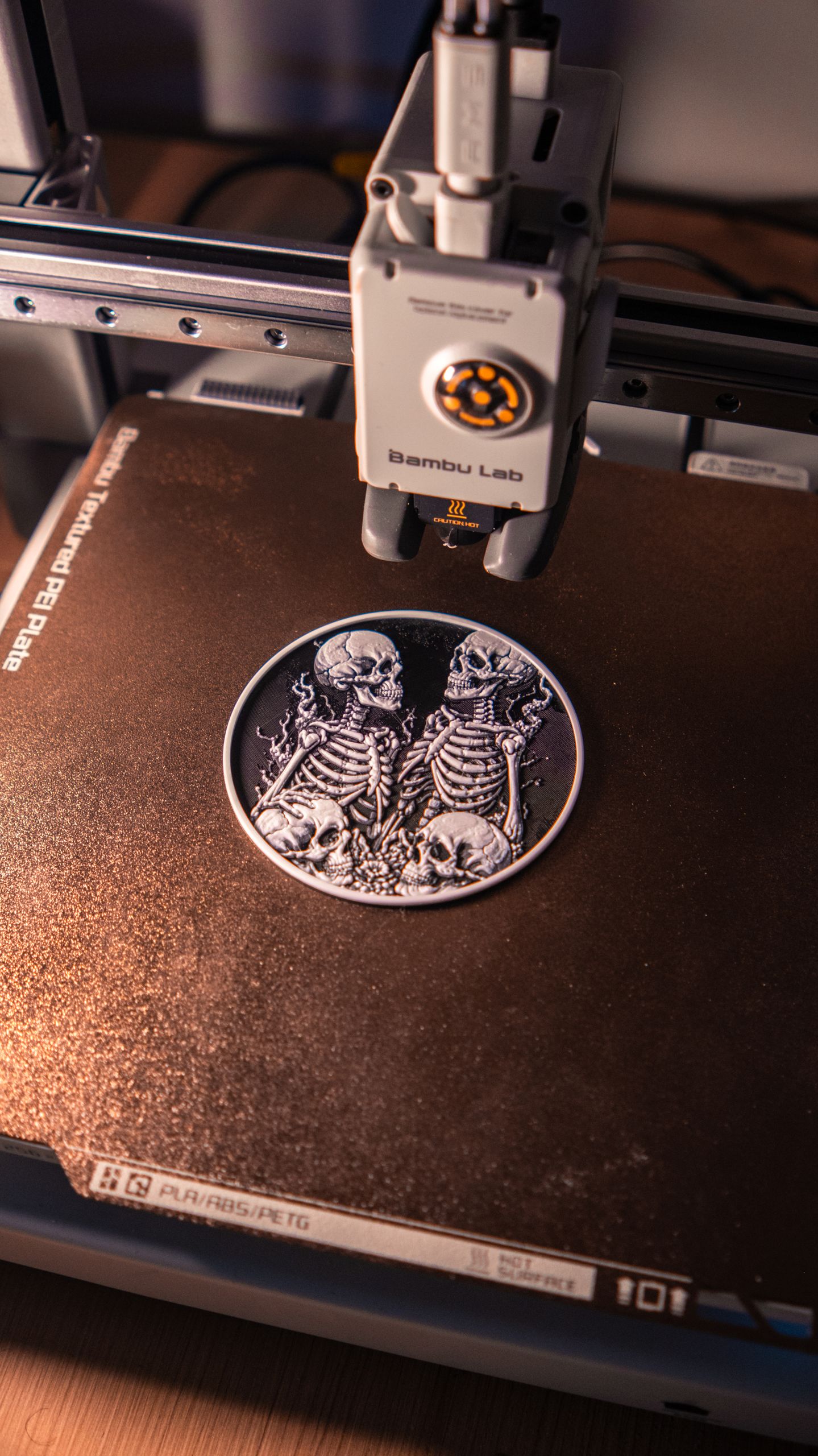 Close-up of an intricate 3D-printed skeleton artwork being created on a 3D printer